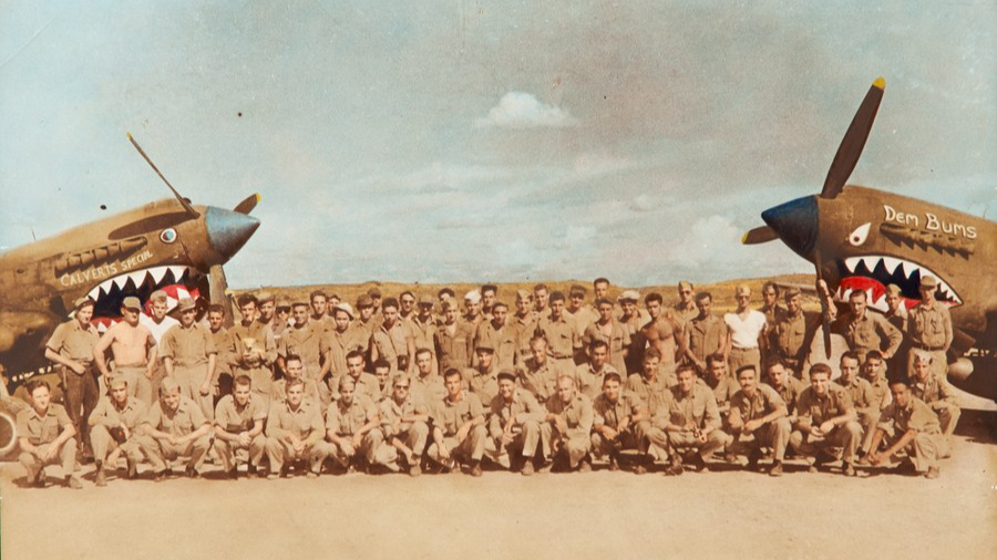 Members of the 76th Squadron of the 23rd Fighter Group of the 14th U.S. Air Force, in which Flying Tiger pilot Glen Beneda served as a pilot, pose for photos in front of two shark-teeth fighter planes in China during World War II. /Xinhua