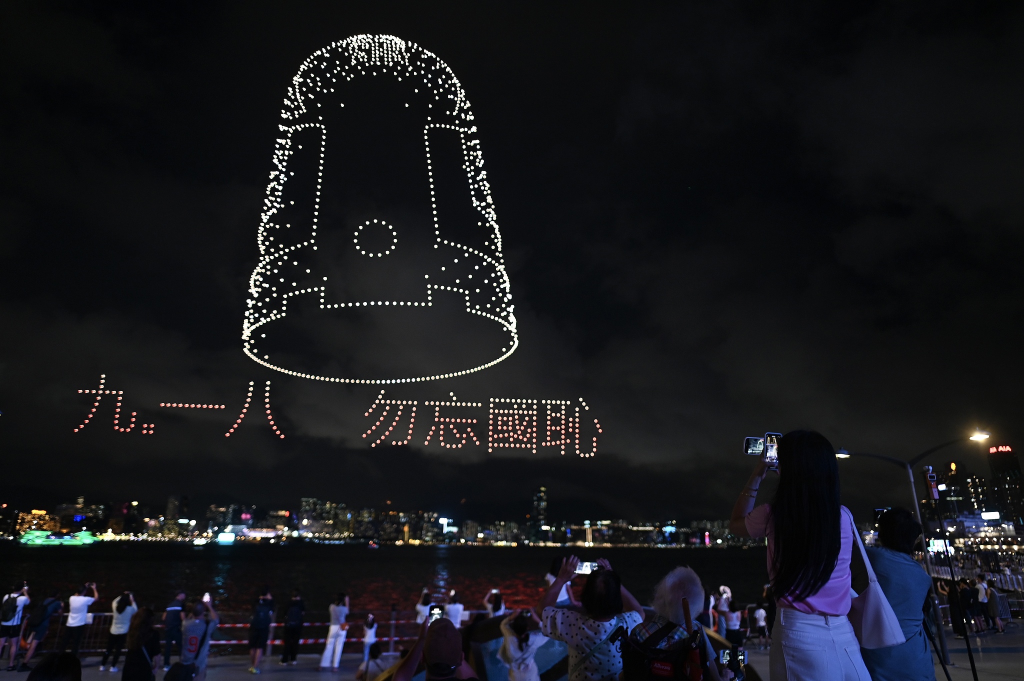 People enjoy a drone show marking the 80th anniversary of War of Resistance in Hong Kong on August 30, 2025. /VCG