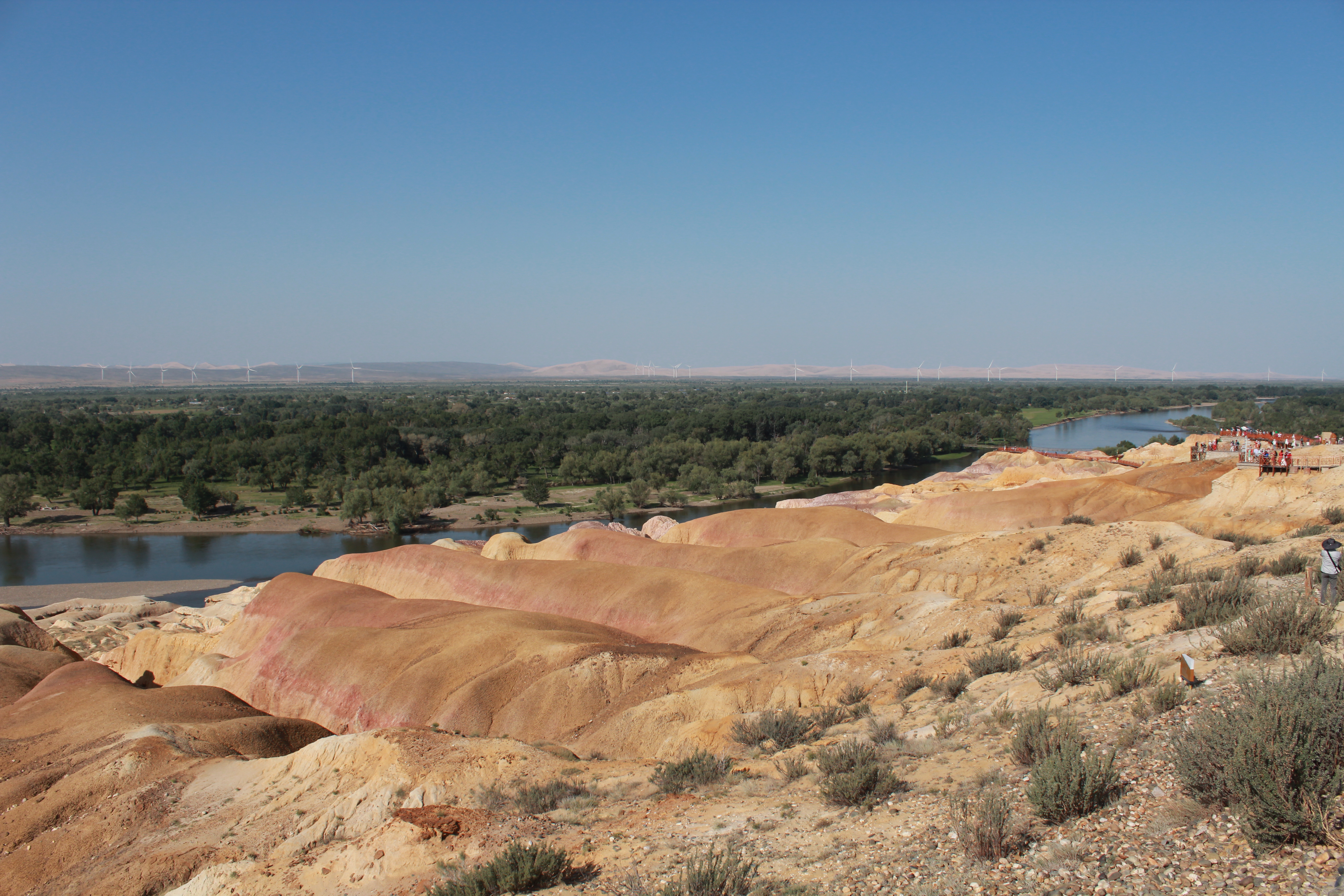 Five-colored Beach Park in Altai Prefecture, Xinjiang astonishes tourists with its rainbow-colored Yardang landform that features sandstone and mud rocks in various hues of red, ocher, and light yellow and green. /CGTN