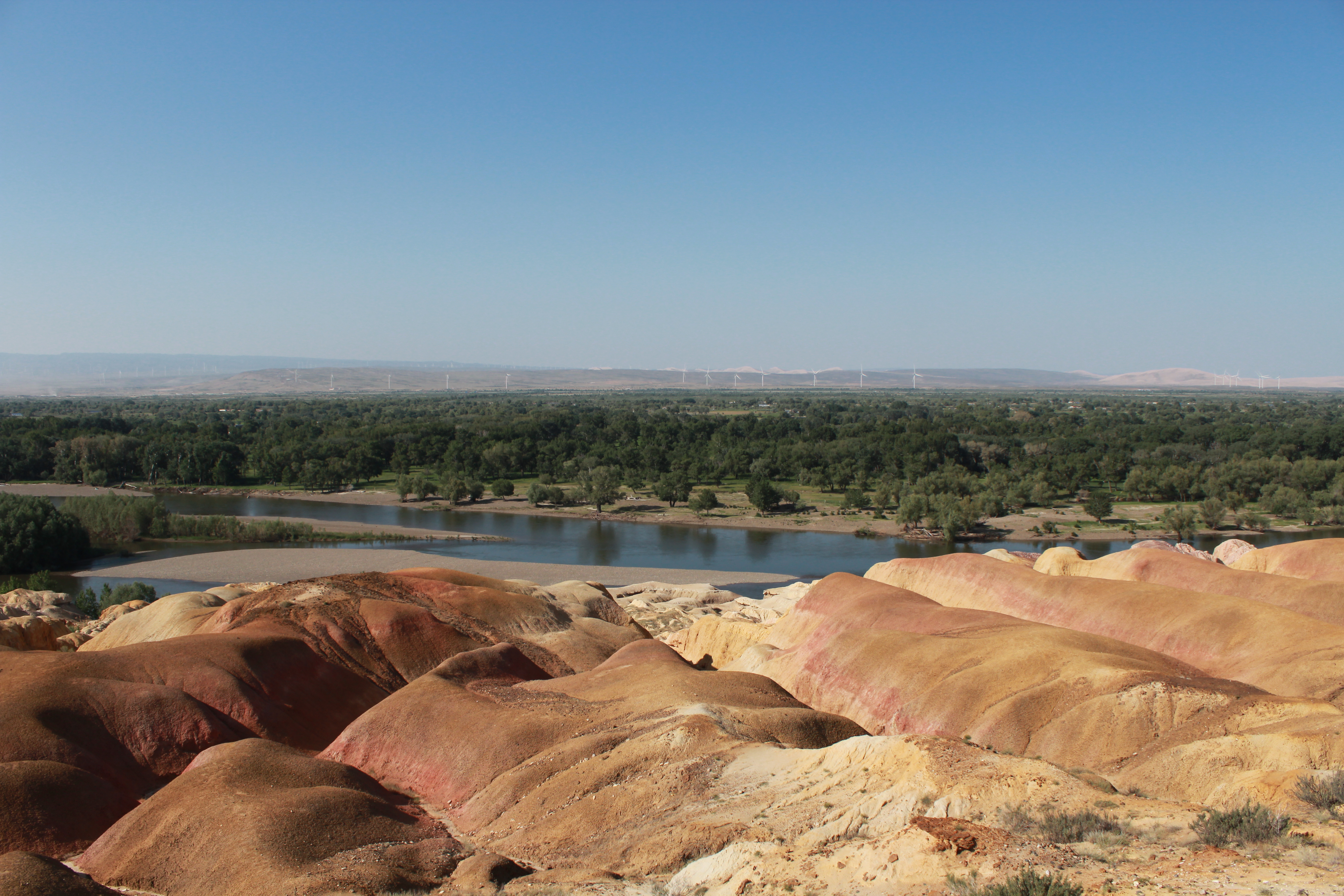 Five-colored Beach Park in Altai Prefecture, Xinjiang astonishes tourists with its rainbow-colored Yardang landform that features sandstone and mud rocks in various hues of red, ocher, and light yellow and green. /CGTN