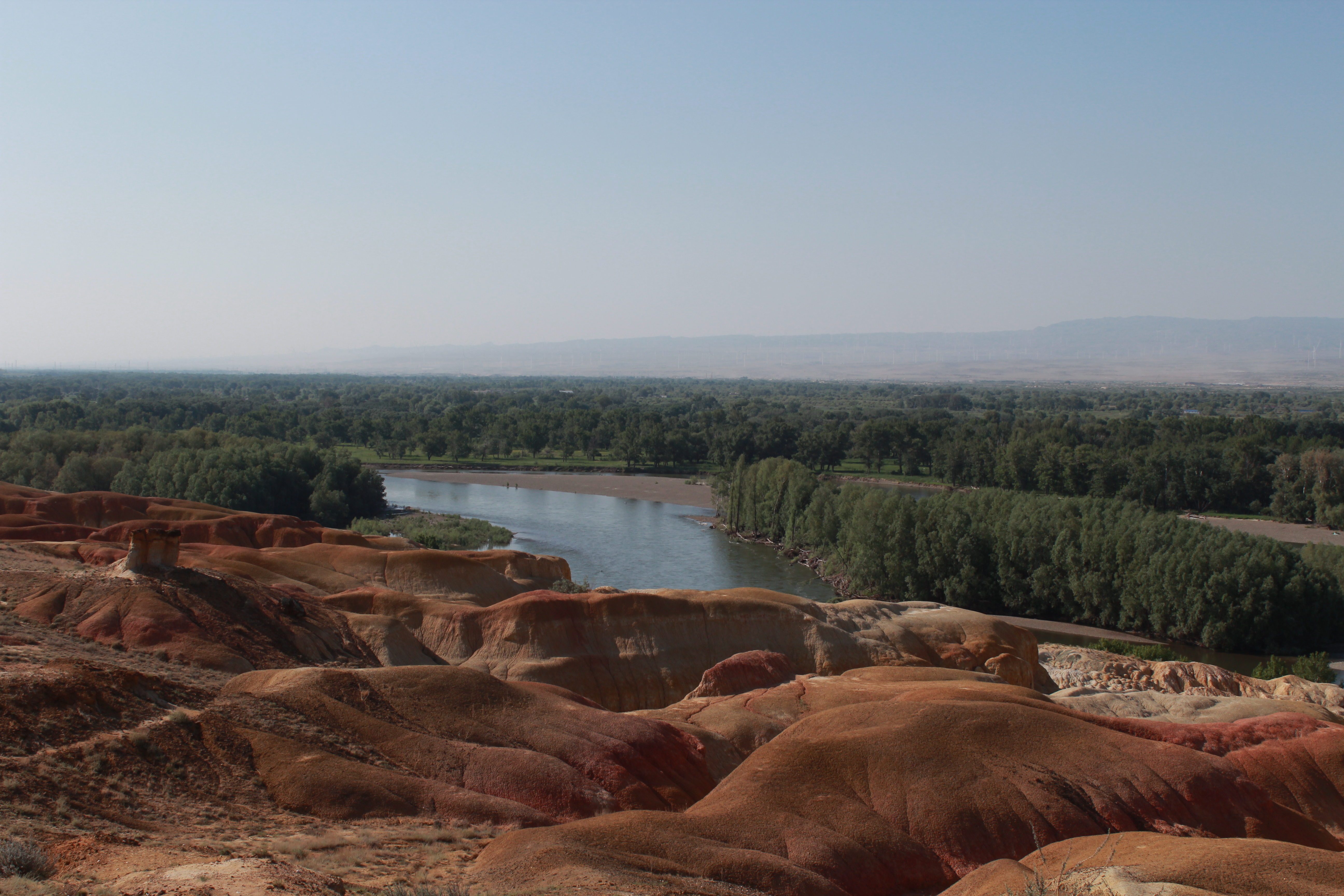Five-colored Beach Park in Altai Prefecture, Xinjiang astonishes tourists with its rainbow-colored Yardang landform that features sandstone and mud rocks in various hues of red, ocher, and light yellow and green. /CGTN