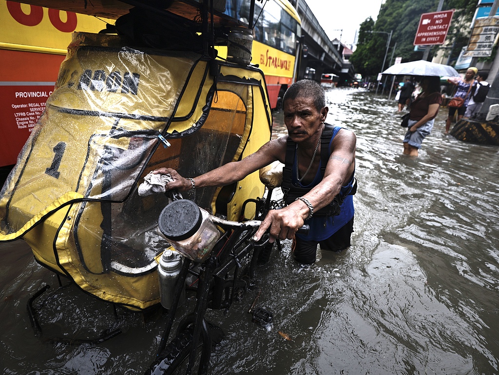 Residents trek along flooded roads in Manila, Philippines, August 22, 2025. /CFP