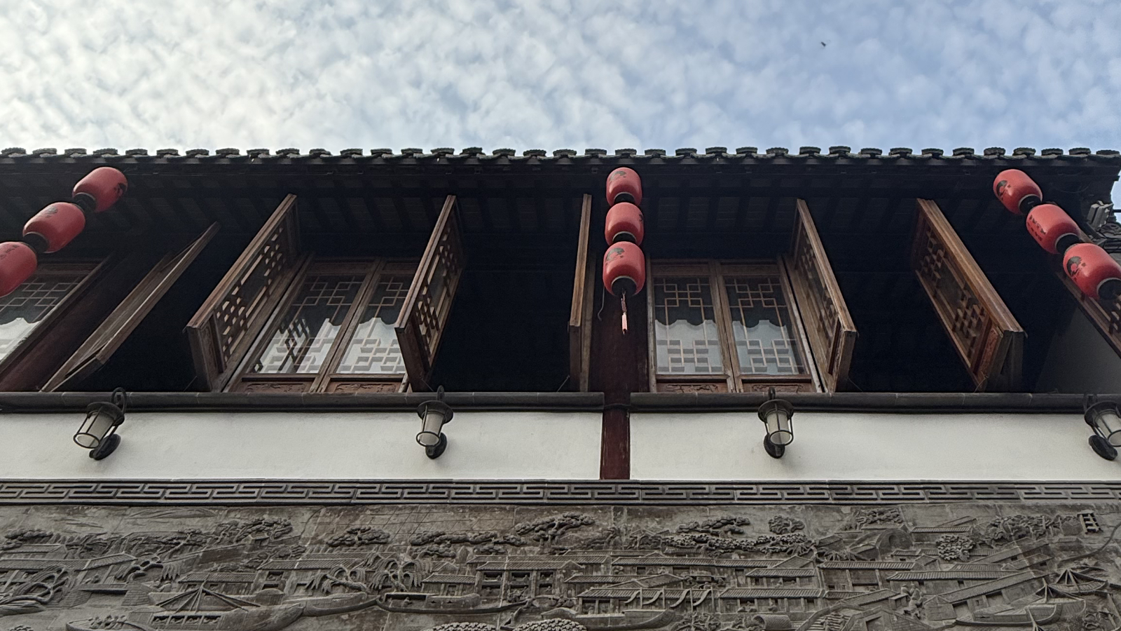 An old house with traditional lattice windows gazes onto the cobblestone street, Tongli Water Town, Jiangsu Province. /Zaruhi Poghosyan   