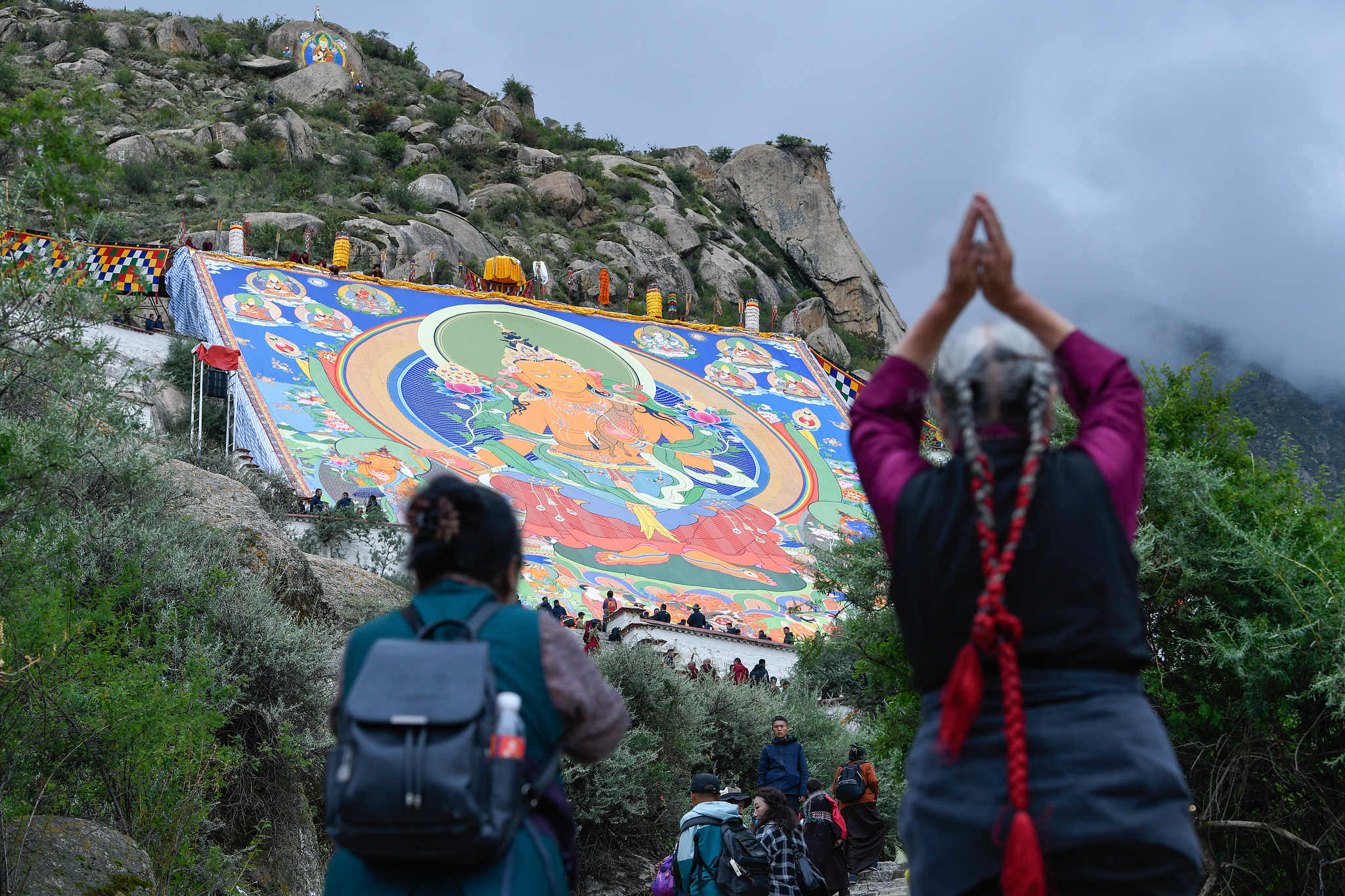 A giant thangka painting of the Jampa Buddha or the Buddha of the future is unrolled at the Drepung Monastery in Lhasa, Xizang, August 23, 2025. /CFP