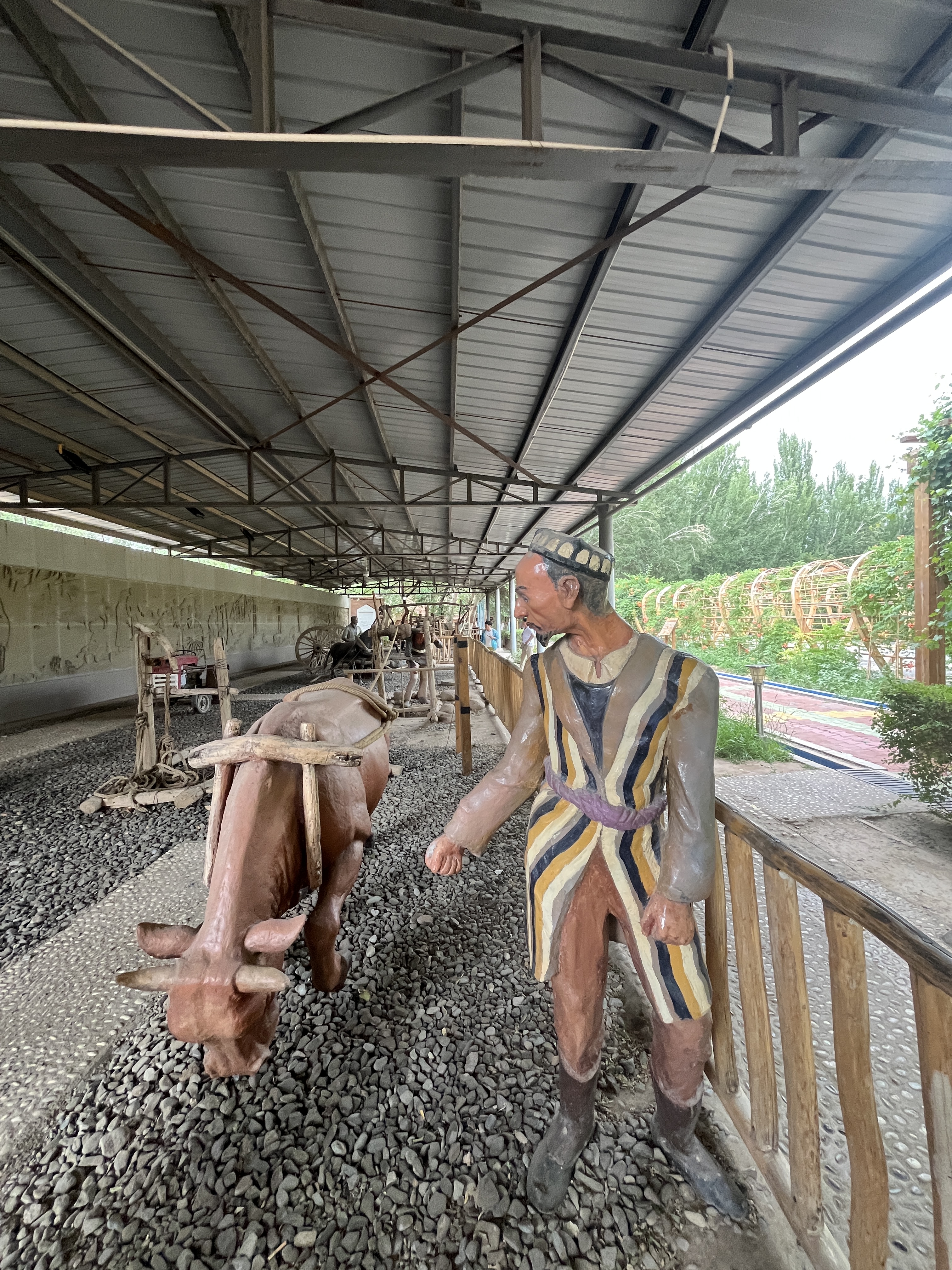 Clay models at the Turpan Karez Paradise museum in Xinjiang depict a cattle-driven winch system used in karez wells. / CGTN