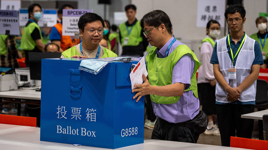 Voting station workers put a ballot box on the table at the ballot counting station in Hong Kong Special Administrative Region, China, September 7, 2025. /VCG