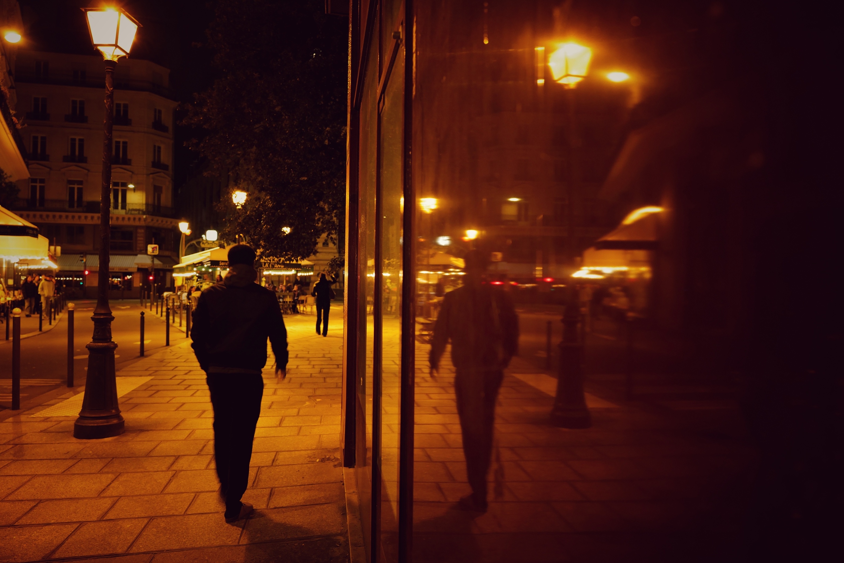 The Weather We Live In: In an age when climate discourse is dominated by statistics and catastrophe, The Weather We Live In offers a quieter, more intimate register. These images were captured in fleeting moments, rain on glass, vapor on café windows, artificial light reflected through condensation. They speak not of disaster, but of atmosphere: the unseen air we share, the shifting weather that binds strangers in public space. Through shadow, color, and texture, the series reflects on how climate is not only a global emergency but a personal and sensory reality, etched into daily urban life. These images ask: what does it mean to feel the climate, to live with it, through it, within it? /Laurent Niddam