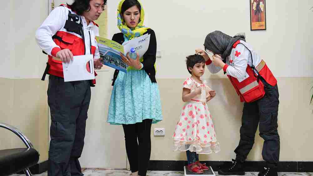 A Chinese medical aid team conducted heart disease screenings for local children in Kabul, Afghanistan, April 14, 2018. This photo captures the registration process before the screening began. These hands, which protect health, not only lift the children's hope for life but also weave the framework of peace on this land – ensuring children can access medical care safely is akin to planting seeds of stability and peace. This act of support embodies the United Nations' goal of 