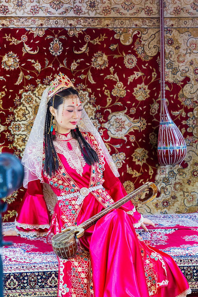 A girl poses for photos at the Xinjiang International Grand Bazaar on September 10, 2025. /VCG