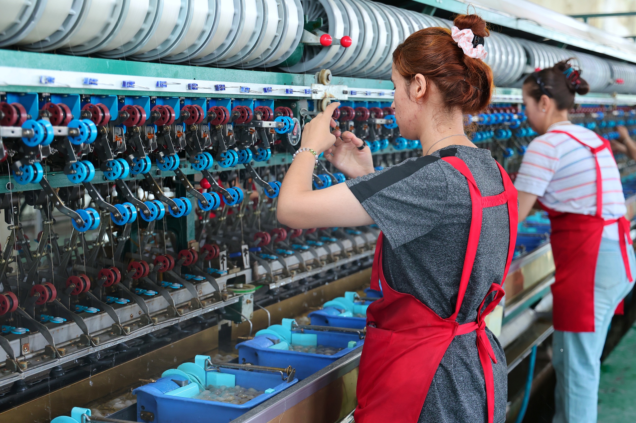 Workers carry out silk reeling production at a silk reeling factory in Wusu City, Xinjiang Uygur Autonomous Region, July 29, 2025. /CFP