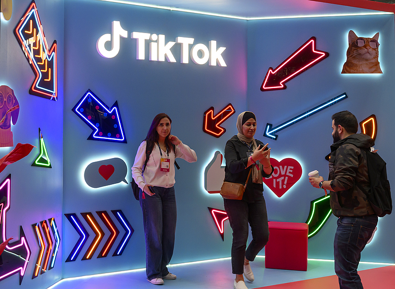 Visitors pose for pictures at the TikTok stand during the second day of the Web Summit in Doha, Qatar, February 24, 2025. /CFP