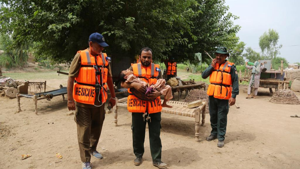 Rescuers transfer a flood affected child from a flood-hit area on the outskirts of Multan, Pakistan, September 2, 2025. /Xinhua