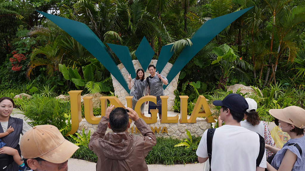 Visitors take photos at the Okinawa JUNGLIA theme park, in Nakijin Village, Okinawa Prefecture, Japan, July 25, 2025. /CFP