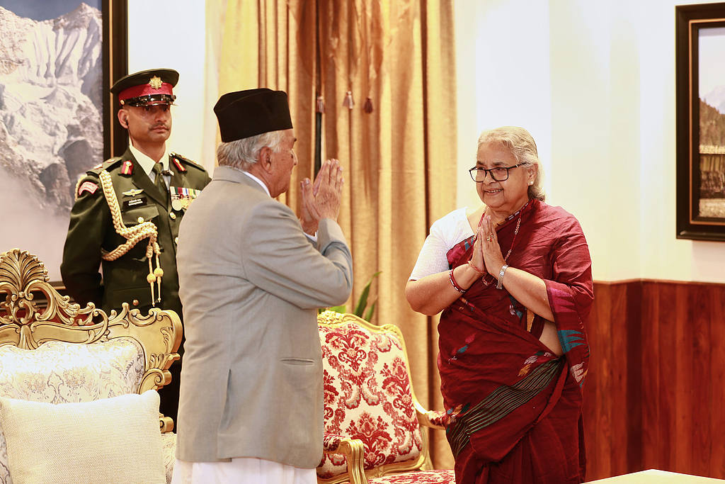 Former Supreme Court Chief Justice Sushila Karki (R) greets Nepalese President Ram Chandra Poudel after taking her oath as interim prime minister during a ceremony at the presidential residence in Kathmandu, Nepal, September 12, 2025. /CFP