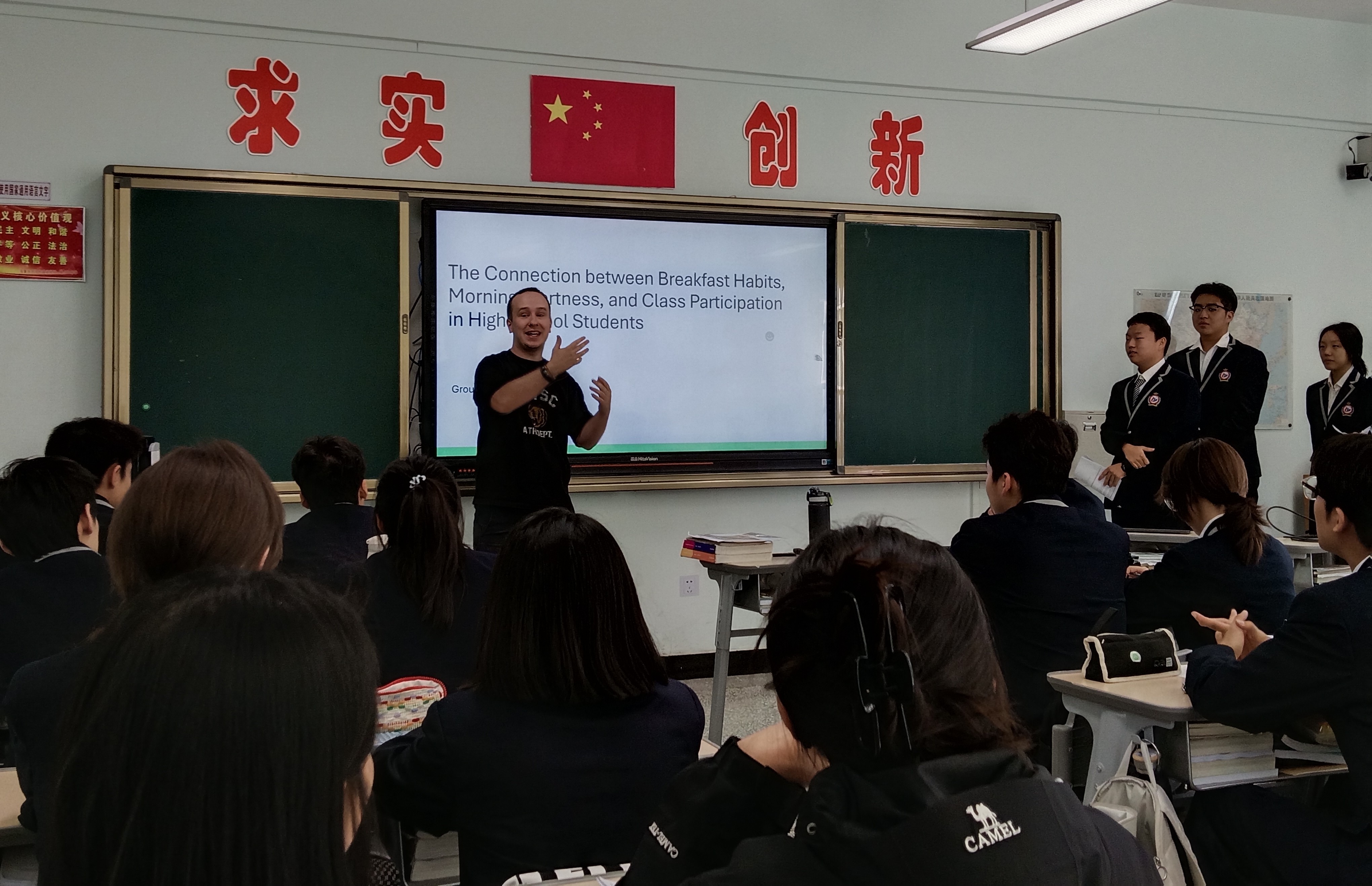 Luke Johnston teaches students how to give Statistical presentations, in Urumqi, Xinjiang, preparing them for when they will all travel abroad to go to university next year, September 12, 2025. /Credit: Luke Johnston