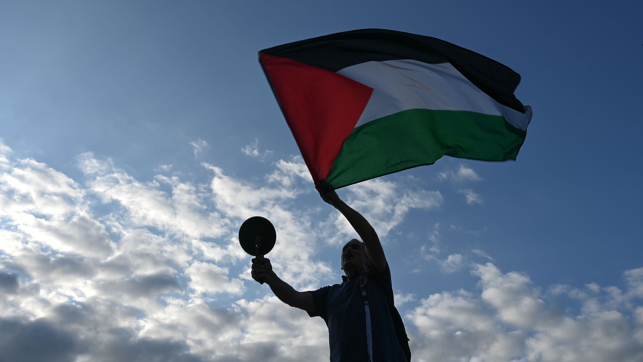 A demonstrator waves a Palestinian flag during a 