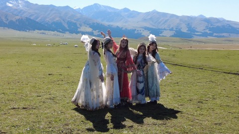 Tourists posing for a group photo on the vast Nalati Grassland. /CGTN