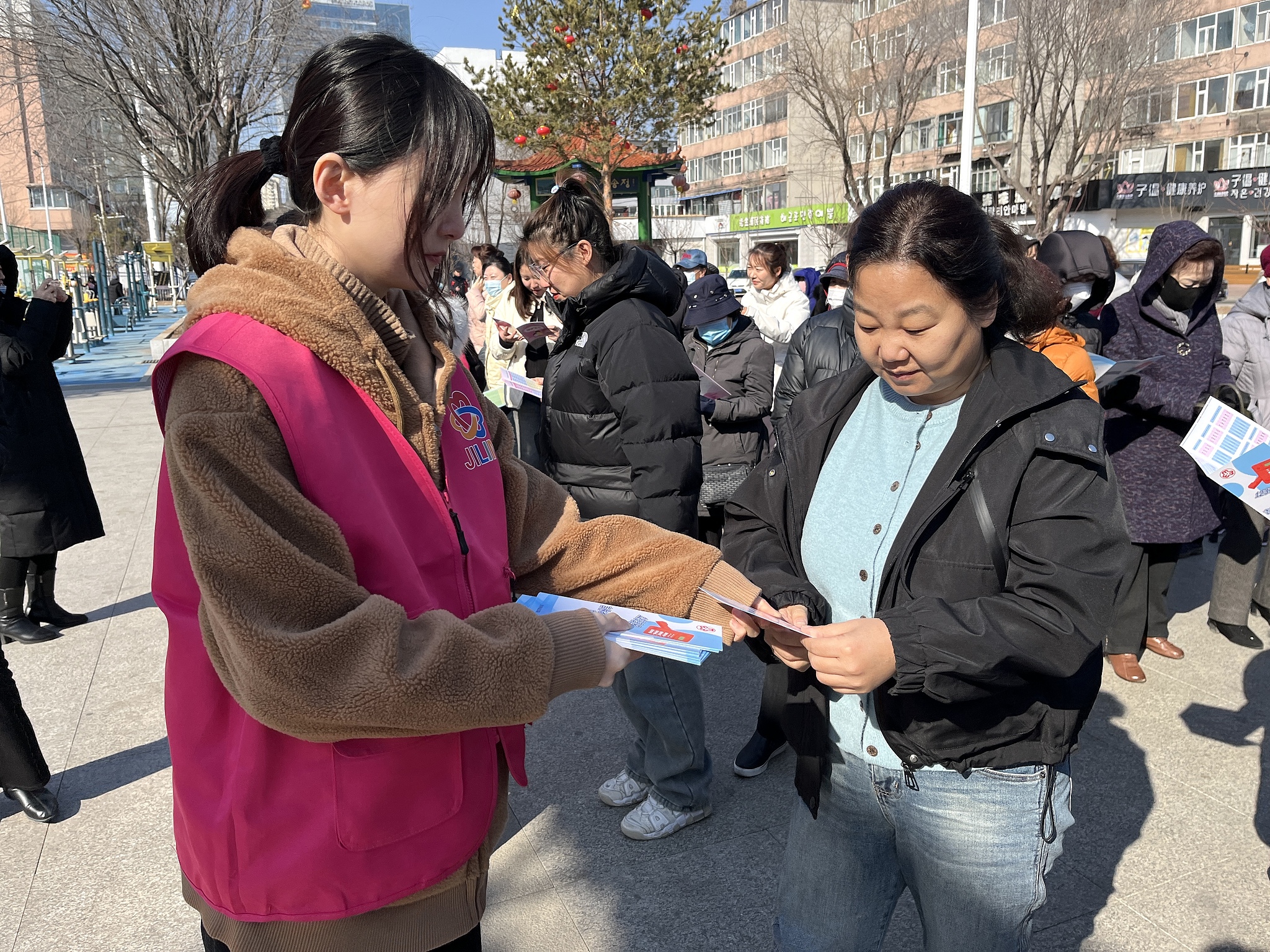 A volunteer hands out cervical cancer prevention and treatment brochures in the Yanbian Korean Autonomous Prefecture in Jilin Province, China, March 14, 2025. /CFP