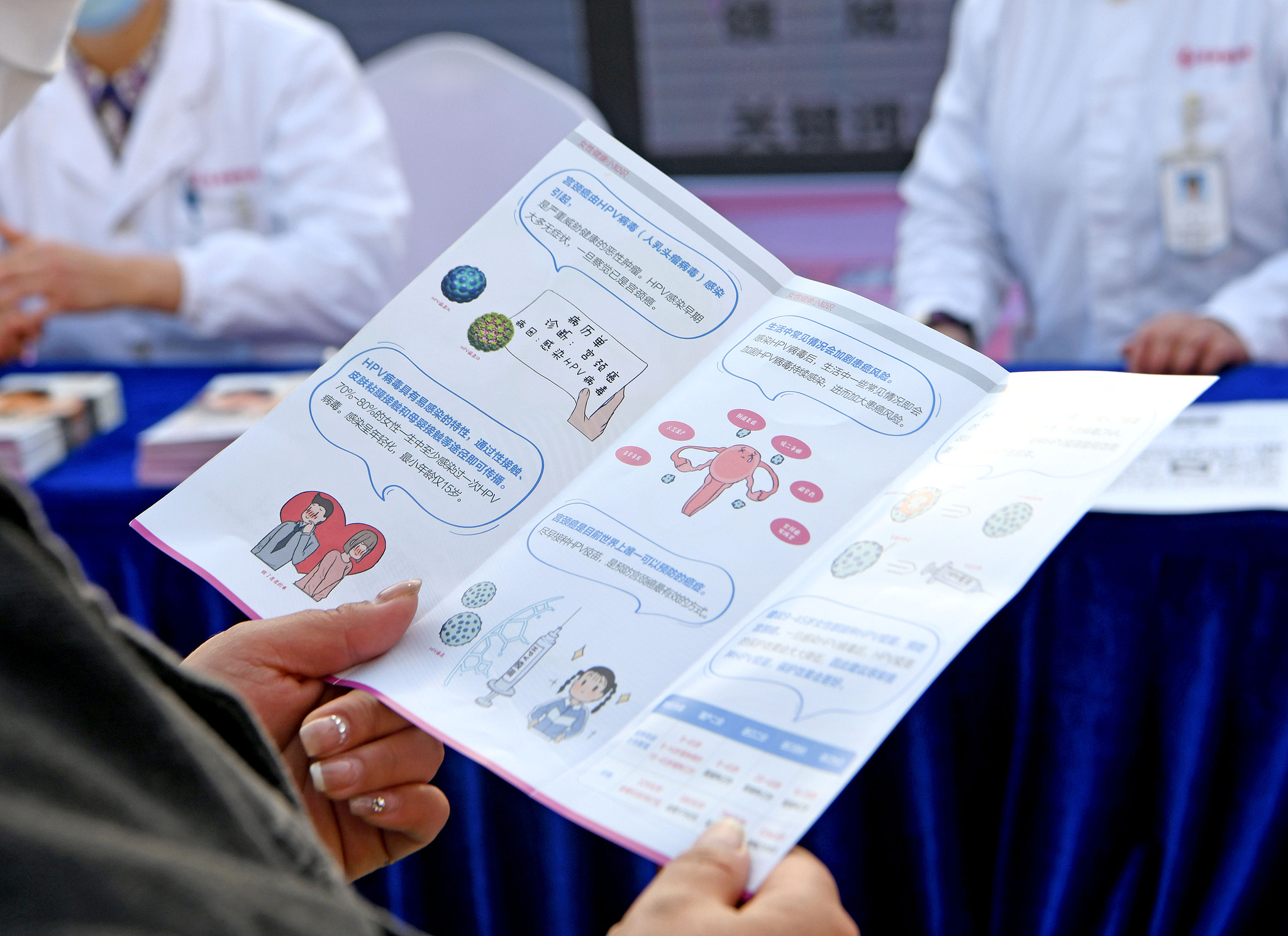 A woman reads a cervical cancer prevention and treatment brochure in Huainan, Anhui Province, China, March 5, 2023. /CFP