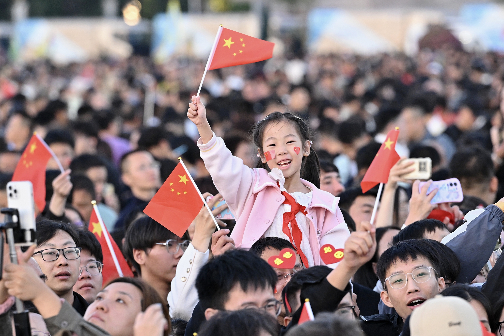 People attend a flag-raising ceremony marking the 76th anniversary of the founding of the People's Republic of China at Tiananmen Square in Beijing, capital of China, October 1, 2025. /VCG