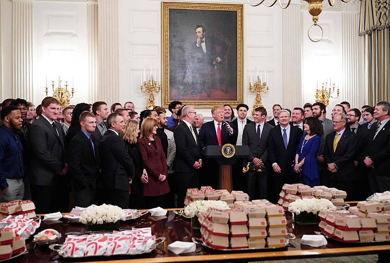 US President Donald Trump speaks behind a table of fast-food during an event in the State Dining Room of the White House in Washington, DC, on March 4, 2019. A spread of french fries, 