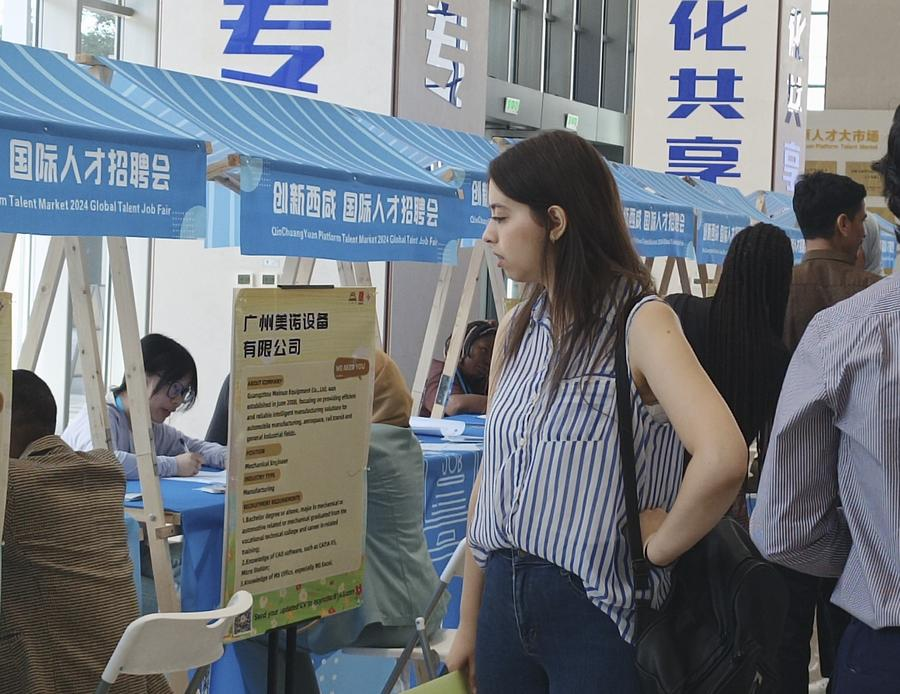A young foreigner looks on at a job fair at a talent market in Xi'an, northwest China's Shaanxi Province, May 17, 2024. /Xinhua