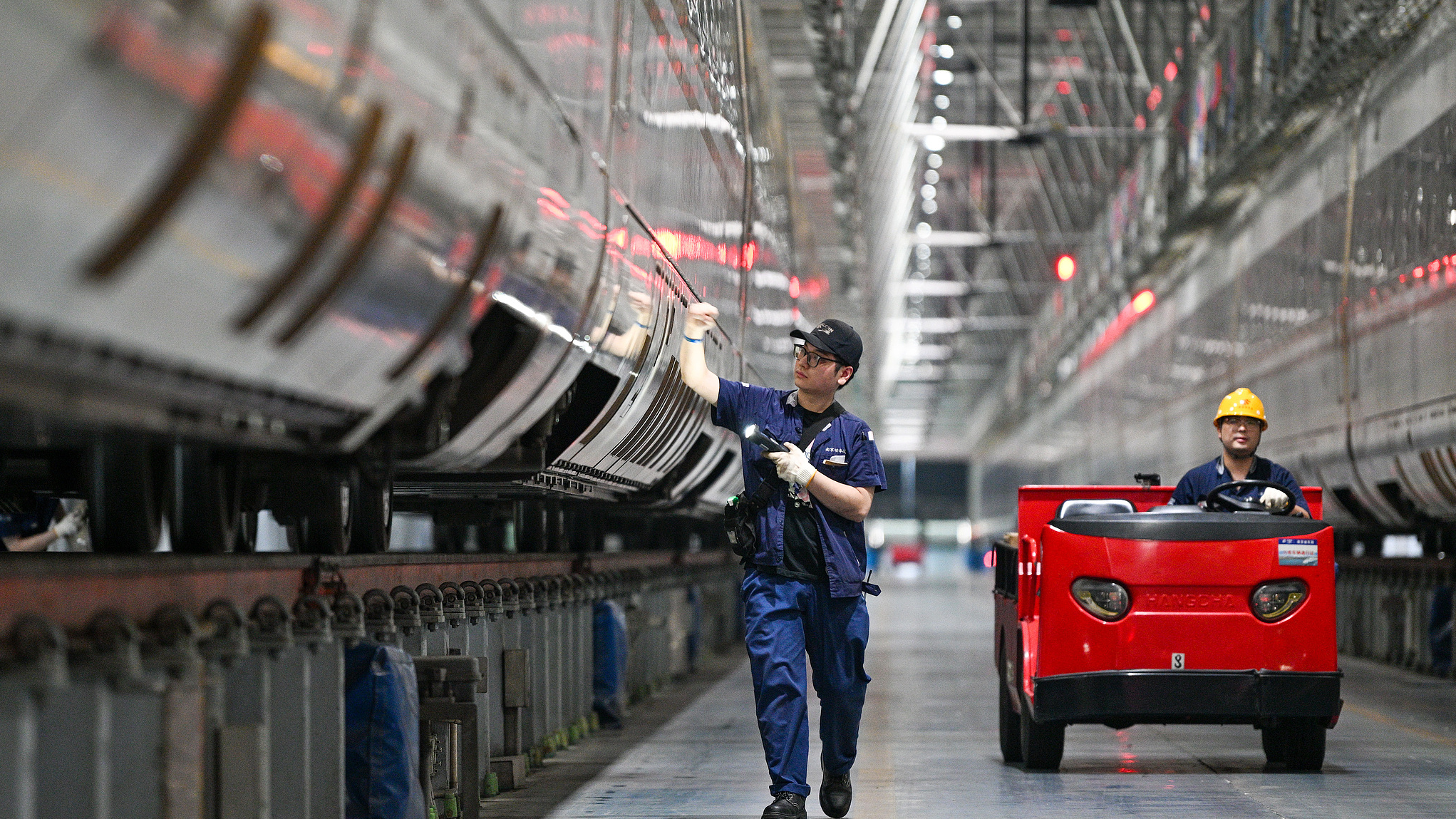 Railway staff inspect the trains at a railway station in Nanjing City, east China's Jiangsu Province, October 1, 2025. /VCG