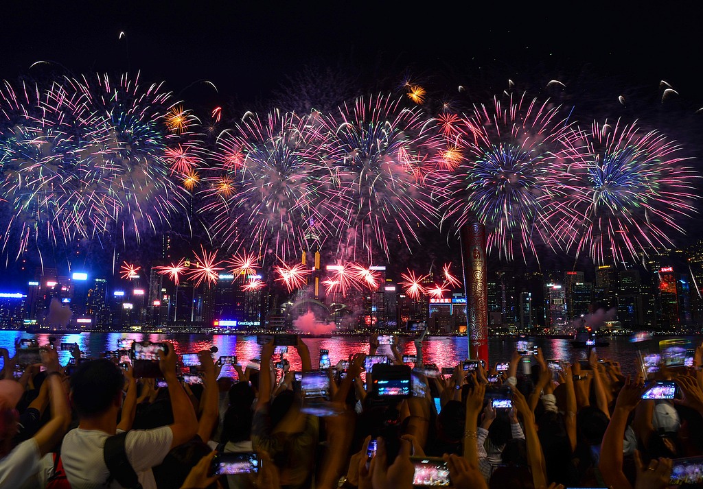 People watch a fireworks display over Victoria Harbour in Hong Kong, October 1, 2025. /VCG