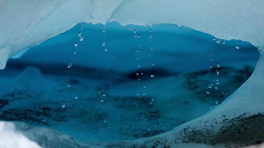 Water drips from a melting chunk of ice that originated from the Rhone Glacier near Goms, Switzerland, June 10, 2025. /VCG