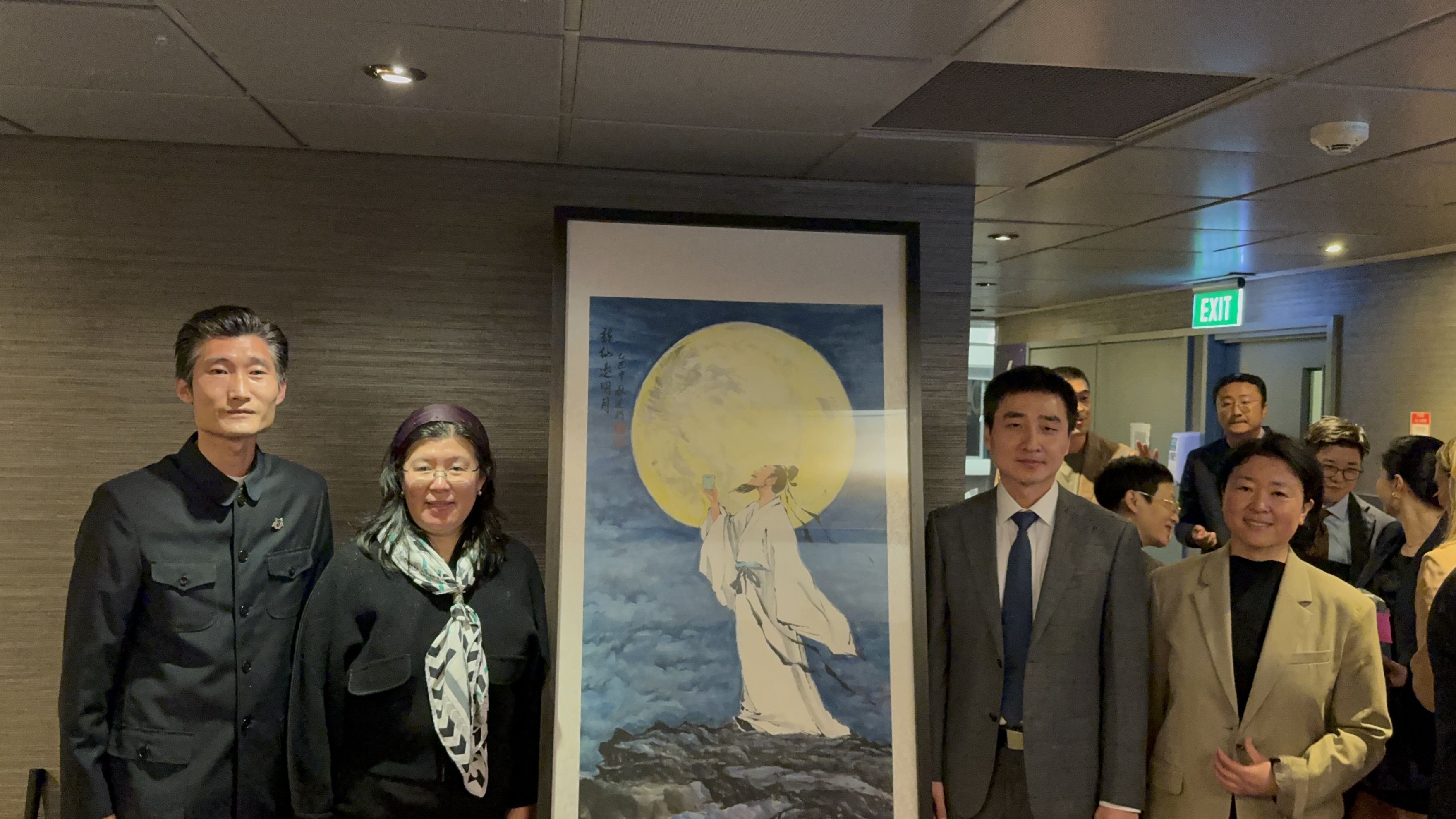 From left to right, President of the New Zealand International Art Exchange Association Alan Wang Yanke, Cultural Counselor of China in Auckland Lou Baiqian, Acting Consul General of China in Auckland Wang Junchao and Education Consul in the Chinese Consulate in Auckland Yu Liqun, attend an unveiling ceremony before the painting was projected onto the iconic 328-meter-high Auckland Sky Tower on the night of October 3, 2025. /Photo provided to CGTN