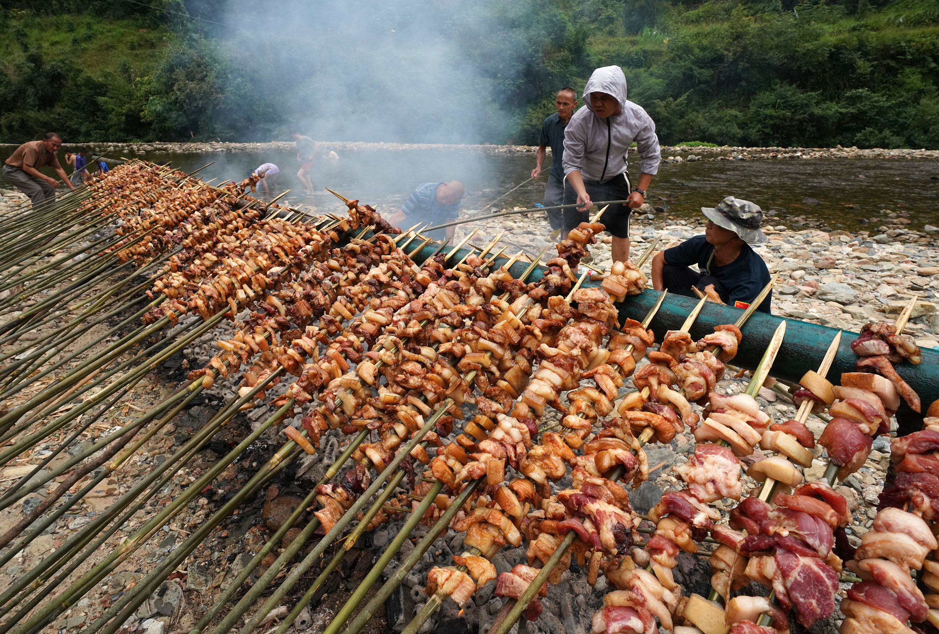 A barbecue party is held to celebrate the ongoing National Day holiday at Yuanbao Village, Rongshui Miao Autonomous County, south China's Guangxi Zhuang Autonomous Region, October 3, 2025. /IC