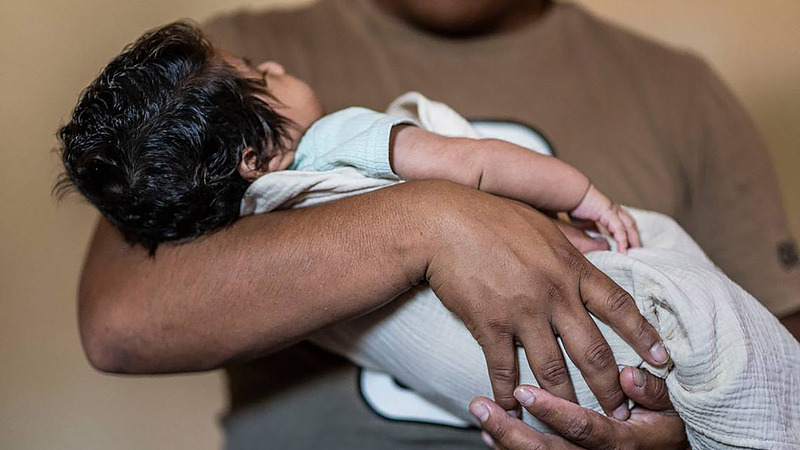 A father, requesting anonymity for fear of deportation and retaliation, holds his son. The baby, born a month earlier, is the only family member who is a U.S. citizen through the longstanding guarantee of birthright citizenship under the 14th Amendment, recently challenged by an executive order from U.S. President Donald Trump, Sacramento, California, June 2025. /VCG