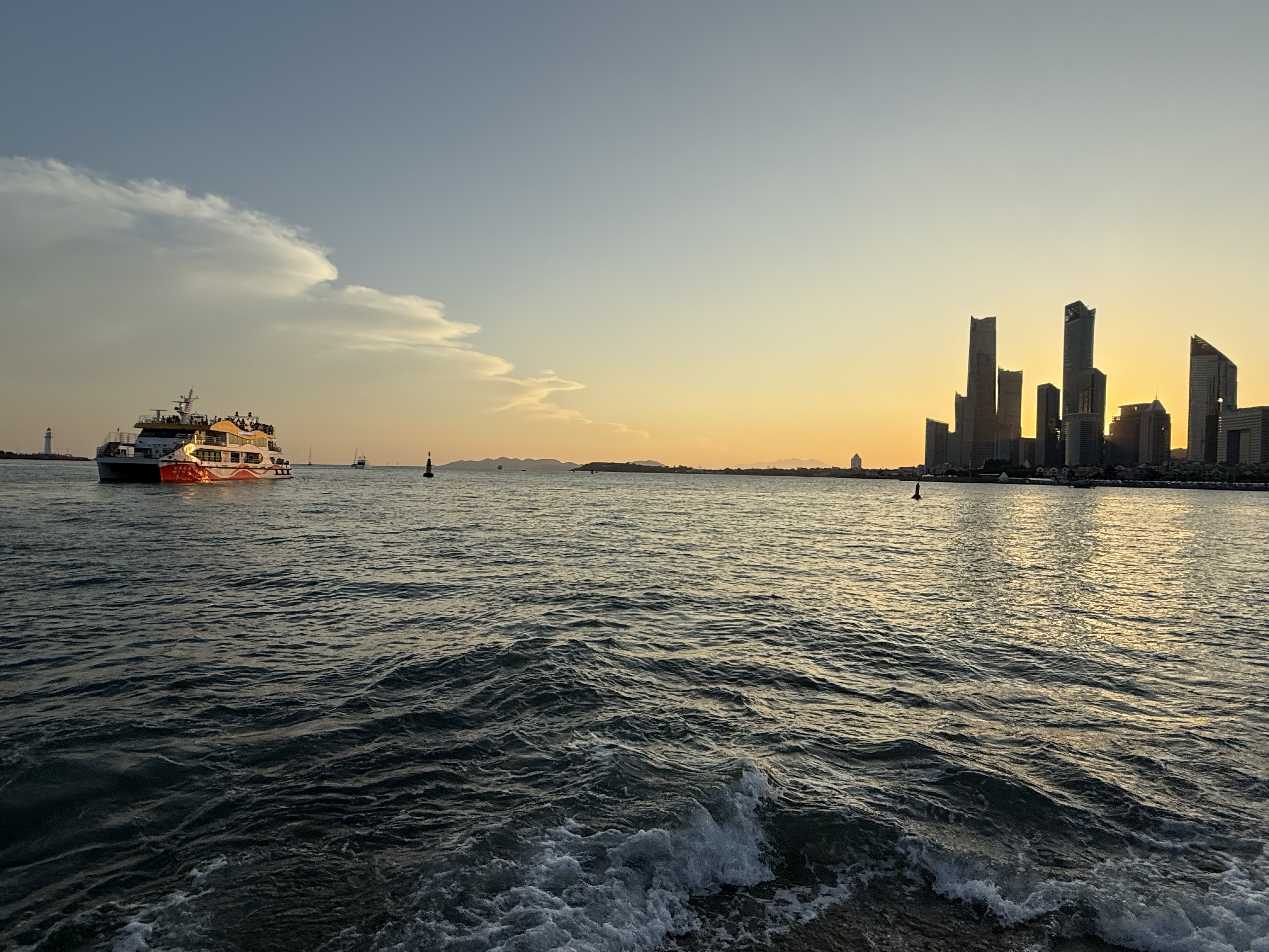 Dusk settles over the sea as a ship drifts across the horizon, September 2025, Qingdao, China /Zaruhi Poghosyan