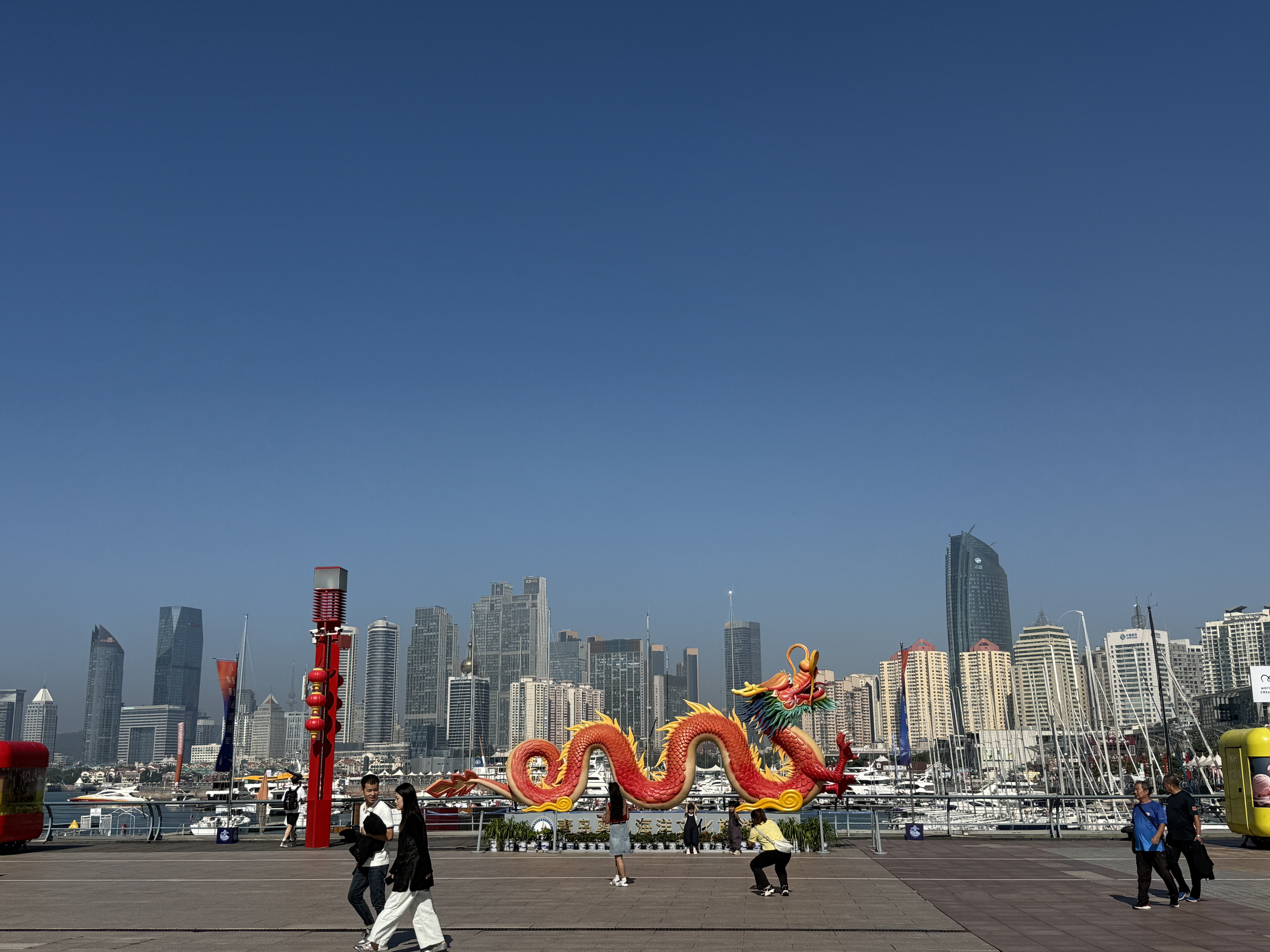 A red Chinese dragon installation stretches along the seaside promenade, September 2025, Qingdao, China /Zaruhi Poghosyan
