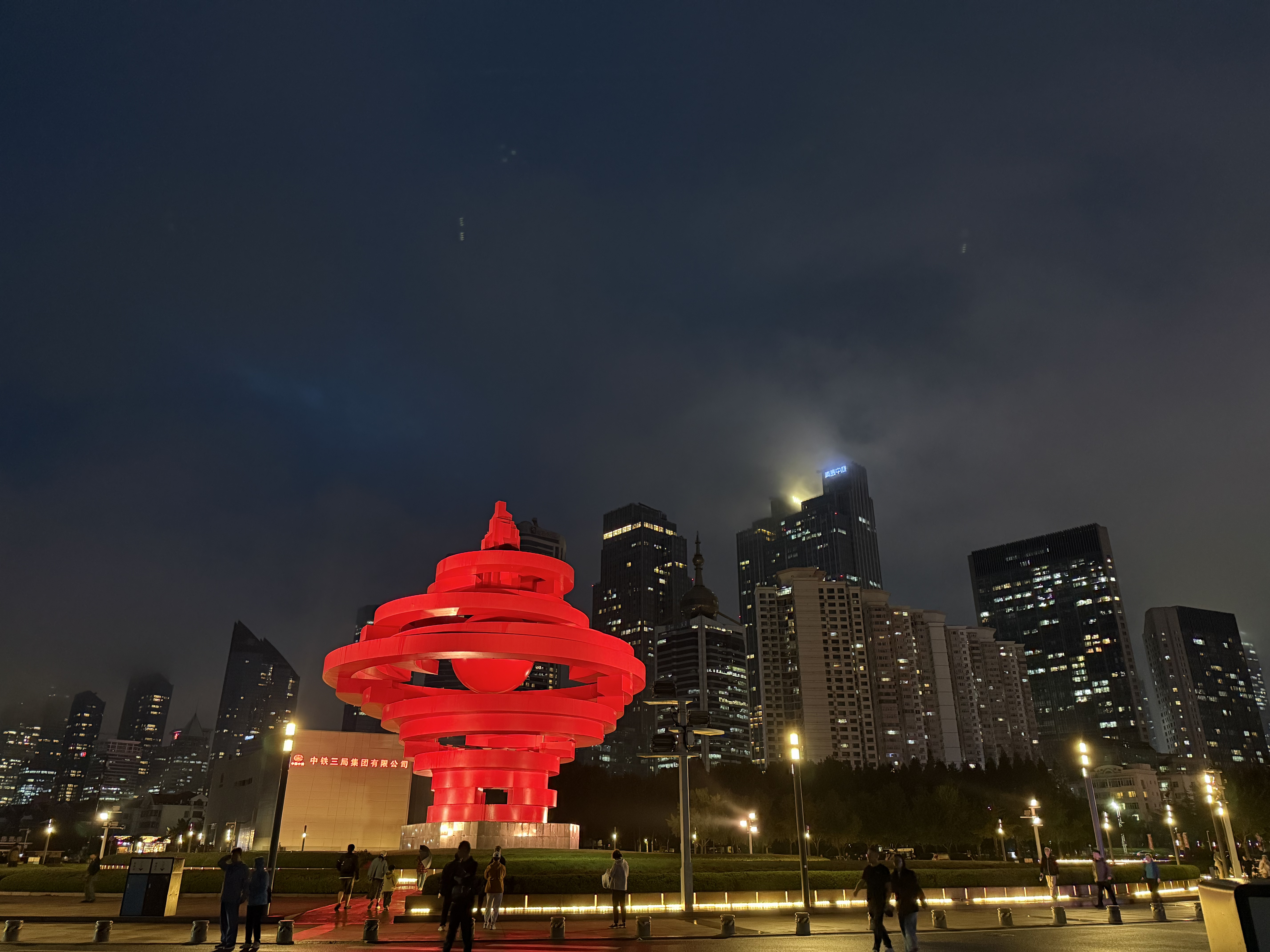 The iconic May Fourth Square red sculpture rises against Qingdao's illuminated skyline, September 2025, Qingdao, China /Zaruhi Poghosyan