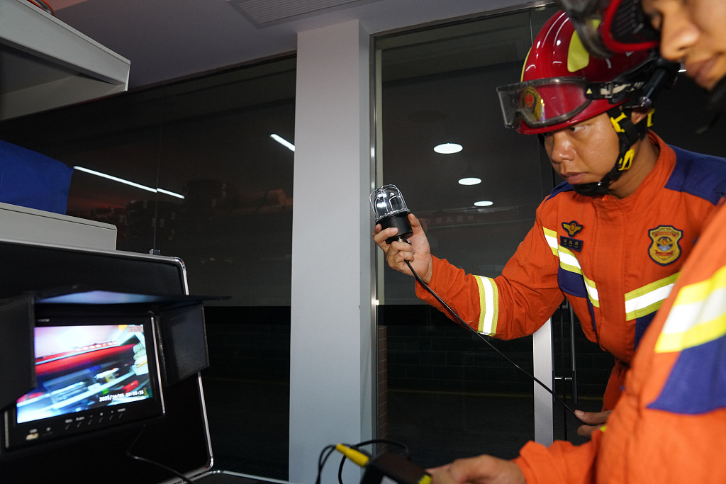 Firefighters inspect an underwater camera at the Tinghong Road Fire and Rescue Station in Jiangnan District, Nanning, Guangxi Zhuang Autonomous Region, south China, October 5, 2025. /VCG