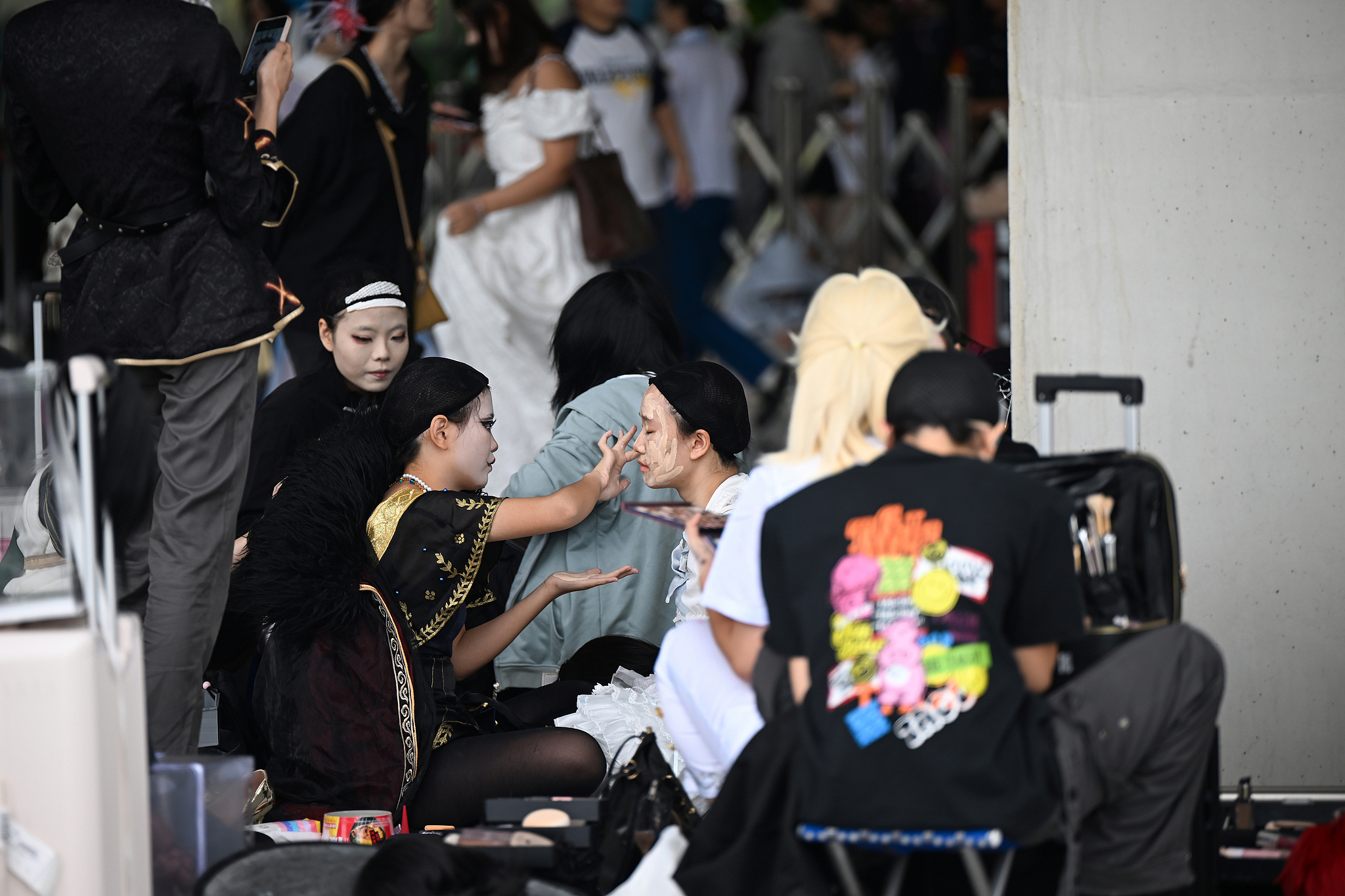 A makeup artist does makeup for the cosplayer at the World Line Anime Exhibition at Chengdu City, southwest China's Sichuan Province, October 1, 2025. /CFP