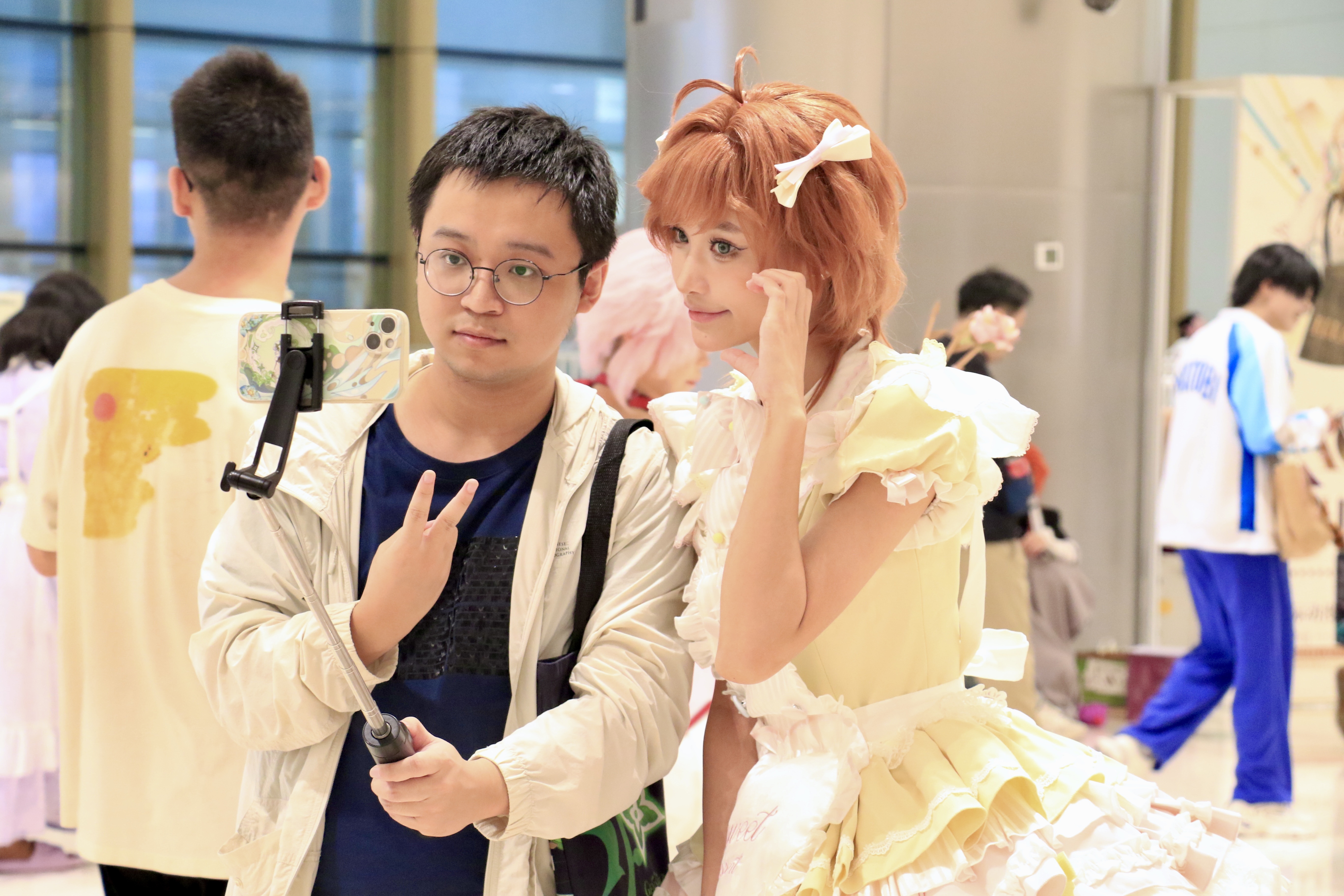 A man takes photos with a cosplayer at the IAGF at Hangzhou City, east China's Zhejiang province, October 2, 2025. /CFP