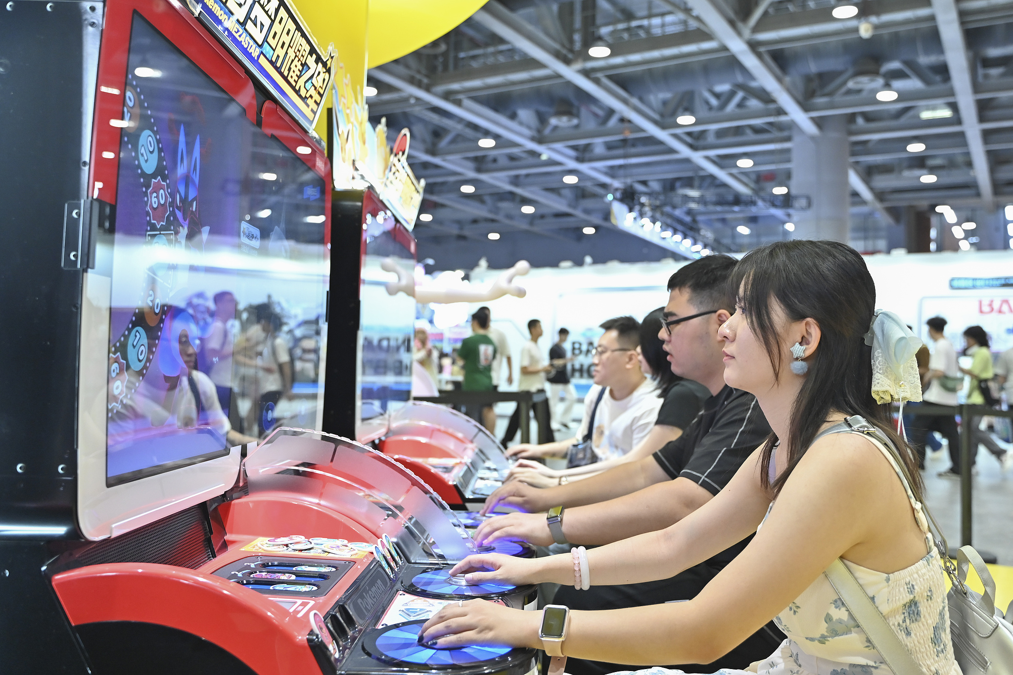 A few people play arcade games at the CICF×AGF Animation and Game Festival in Guangzhou, south China's Guangdong Province, October 2, 2025. /CFP