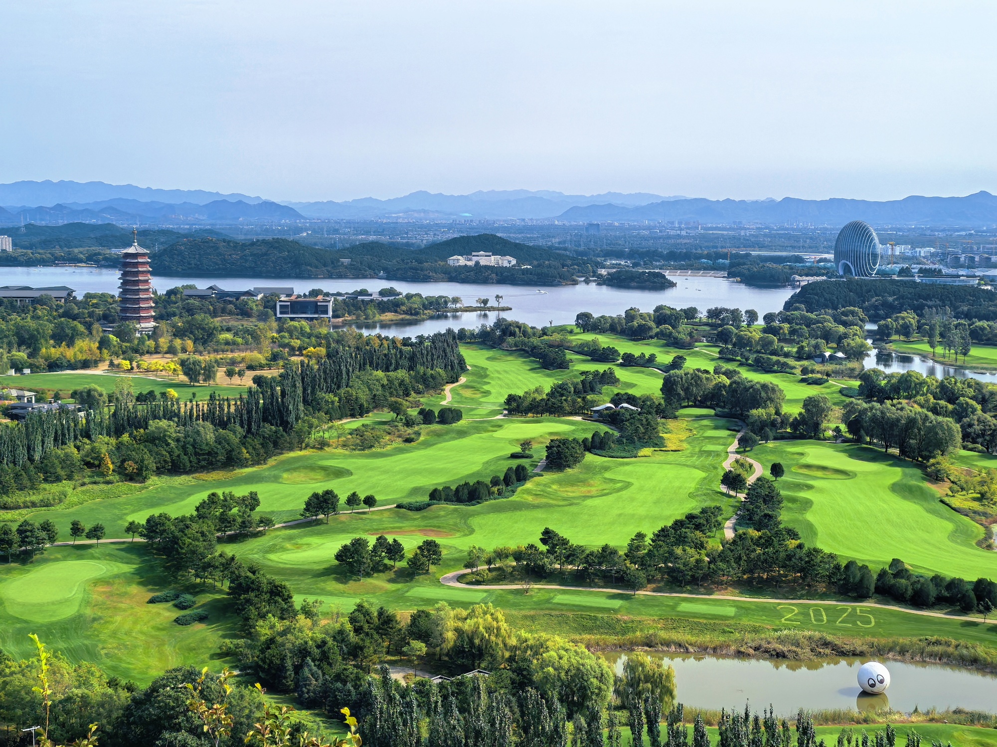 Iconic landmarks like the Yanqi Tower and the Sunrise Kempinski Hotel are seen from Yanqi Lake West Mountain Trail in Beijing, on October 6, 2025. /CGTN
