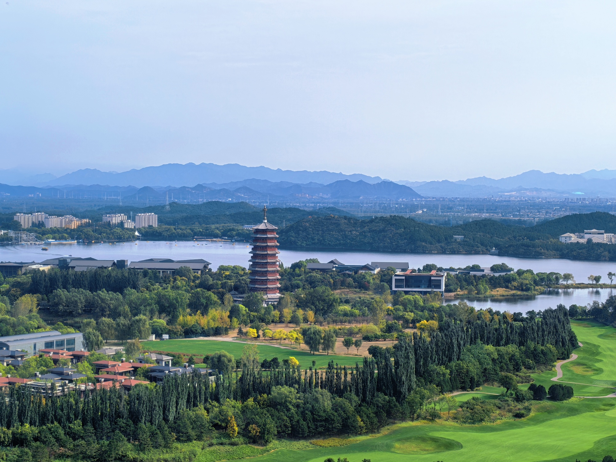The iconic landmark of the Yanqi Tower is seen from the Yanqi Lake West Mountain Trail in Beijing, on October 6, 2025. /CGTN