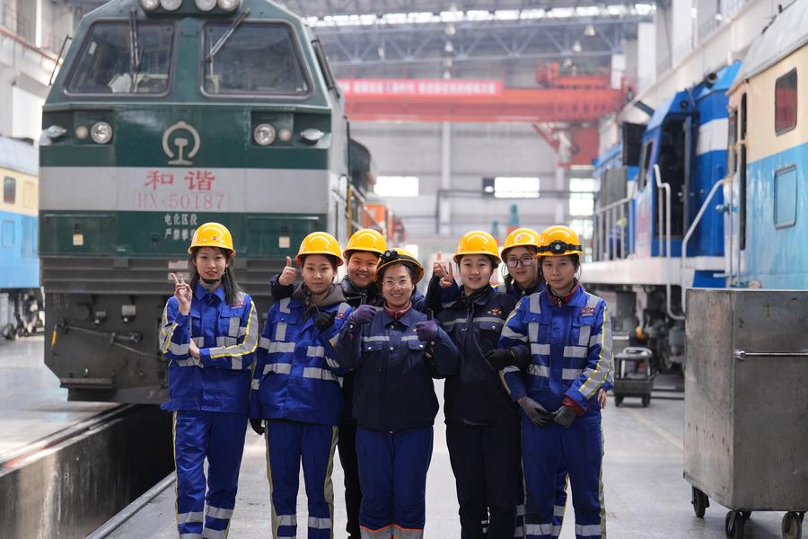 Members of a female maintenance team pose for a group photo at a depot of China Railway Harbin Group Co., Ltd. in Harbin, northeast China's Heilongjiang Province, March 6, 2025. /Xinhua