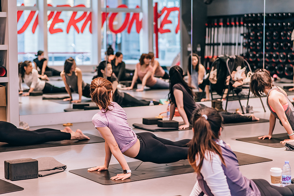A group of women practice yoga at a gym, Shanghai Municipality, east China, March 22, 2019. /VCG