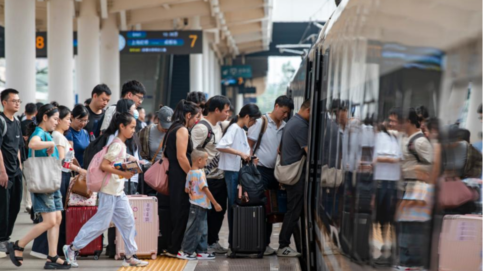 Passengers board a train at Jinhua Railway Station in Jinhua, east China's Zhejiang Province, September 29, 2025. /Xinhua