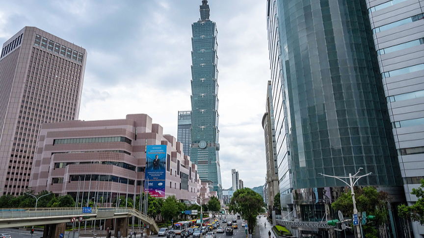Vehicles travel past the Taipei 101 building, center, and other buildings in Taipei, China's Taiwan region, June 3, 2021. /CFP
