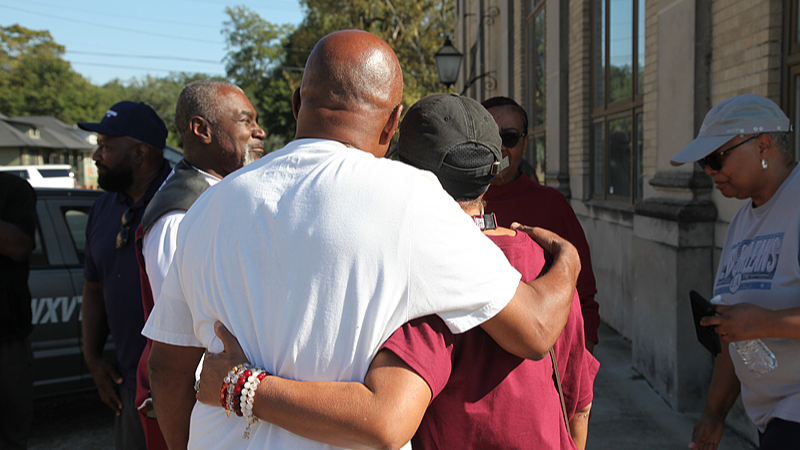 Friends and family of the victims of a shooting, which occurred during a school's homecoming weekend, embrace in downtown Leland, Mississippi, U.S., October 11, 2025. /VCG