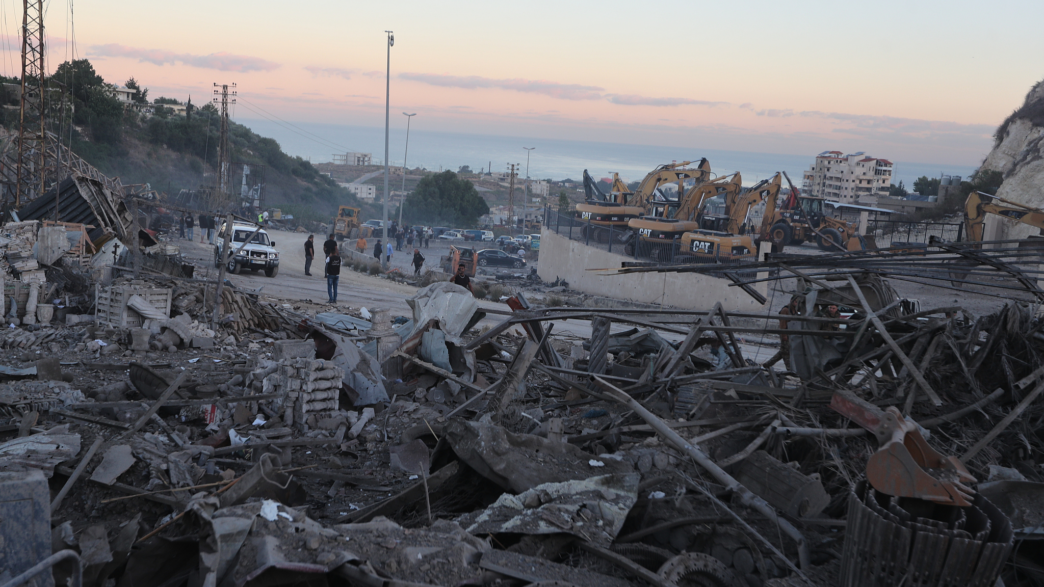 People gather at a site that sold heavy machinery, where a large number of vehicles were destroyed in Israeli air strikes, in the southern village of Msayleh, Lebanon, October 11, 2025. /VCG