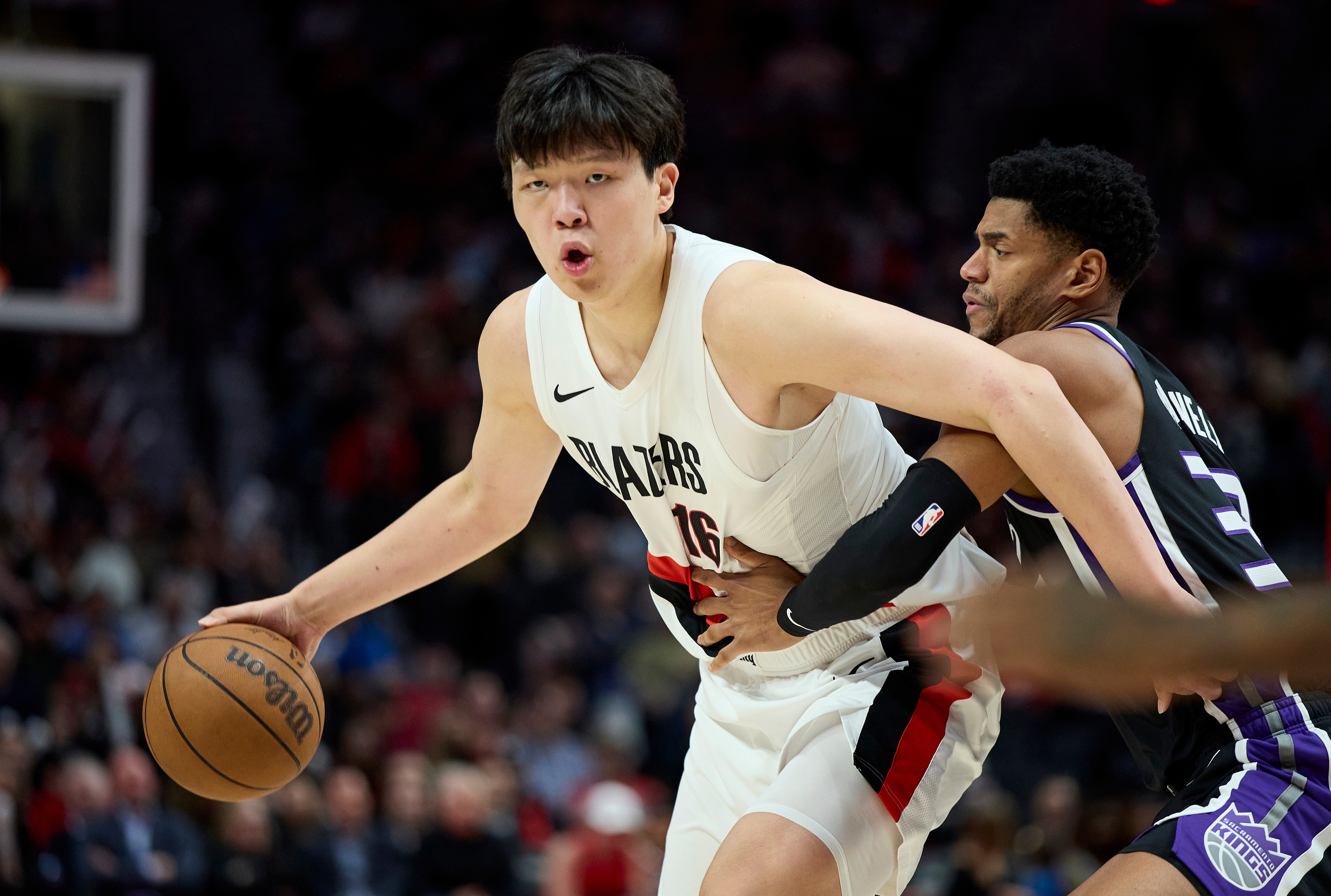 Portland Trail Blazers center Yang Hansen (L) dribbles around Sacramento Kings center Dylan Cardwell in the second half of a preseason NBA game in Portland, Oregon, October 10, 2025. /VCG