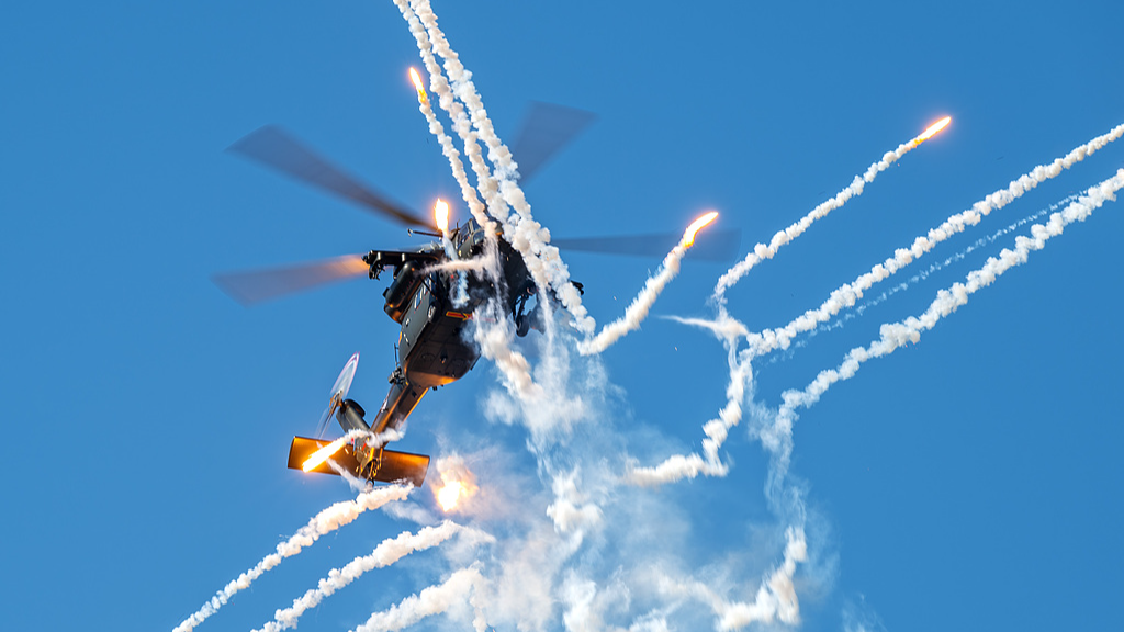 A Z-20 helicopter releases flares during a rehearsal for the 7th China Helicopter Exposition in north China's Tianjin Municipality, October 14, 2025. /VCG