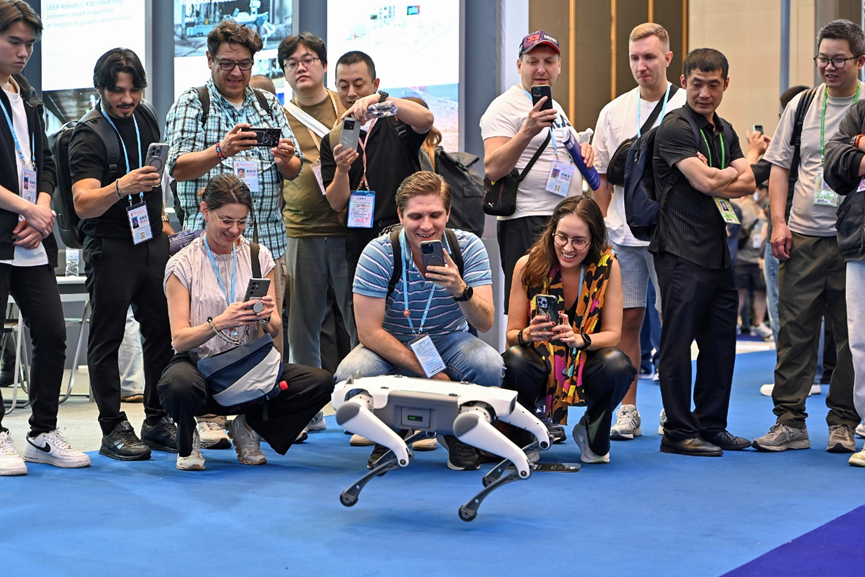 Visitors take photos of a robotic dog during the 137th China Import and Export Fair, in Guangzhou, Guangdong Province, April 15, 2025. /CFP